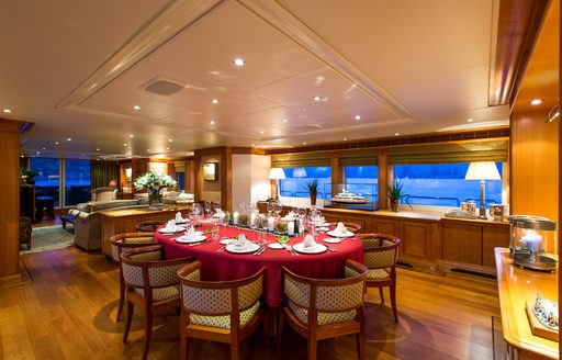 dining table and chairs in main salon of luxury yacht ‘Seven Sins’ 