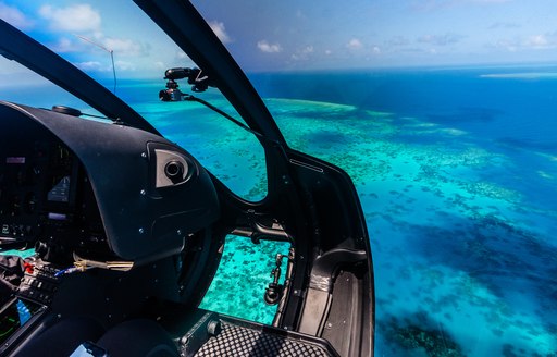 A helicopter flies over the Great Barrier Reef