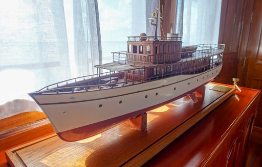 close-up image of a scale model of dickie and sons superyacht over the rainbow following a refit by Mondo Marine. Model located in main salon.