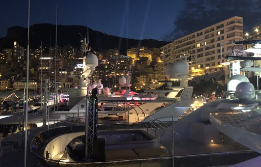 yachts at night at port hercules during monaco grand prix