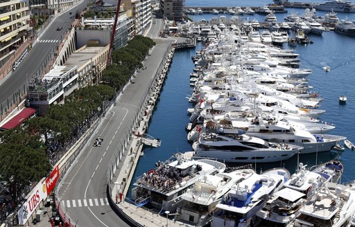 the iconic monaco race track with luxury yachts looking on