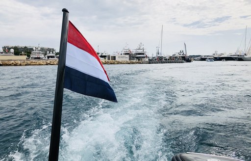 French flag flies on the back of tender shuttle service at Cannes Yachting Festival