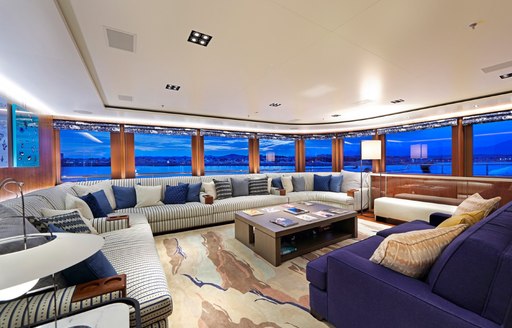 observation lounge with comfortable sofas and sweeping views aboard charter yacht Planet Nine 