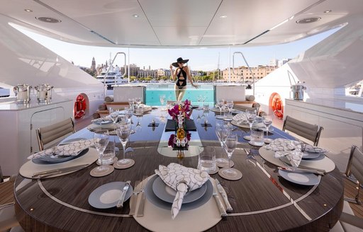 Sundeck on luxury yacht VIDA, woman in background in pool