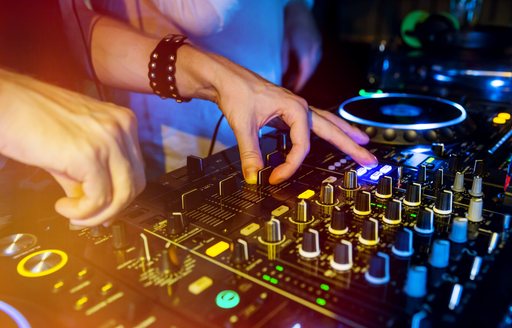 DJ works the decks at a superyacht party