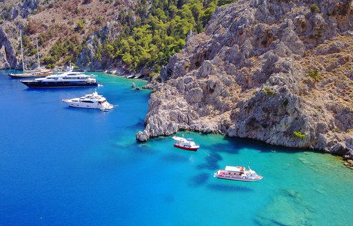 Yachts anchored in a sheltered cove in Greece