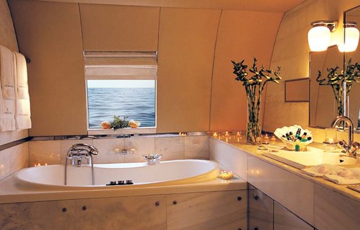 the private ensuite bathroom with beautiful view of the ocean inside the master deck of charter yacht carmen fontana