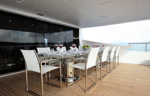 A dining table out on the exterior of luxury yacht WILLOW