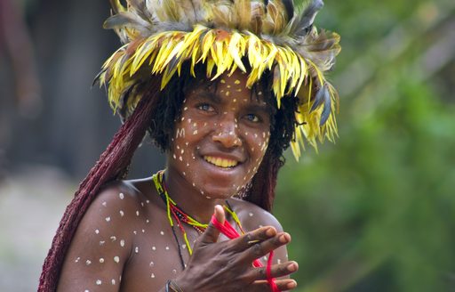 A tribal women in traditional clothes smiles in Indonesia