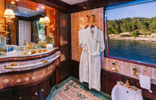 En suite facility with dressing robes onboard charter yacht IDYLLIC