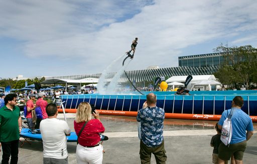 Fly boarding demonstration in large outdoor pool