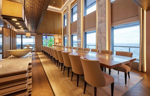 Formal dining table and large windows onboard charter yacht RENAISSANCE