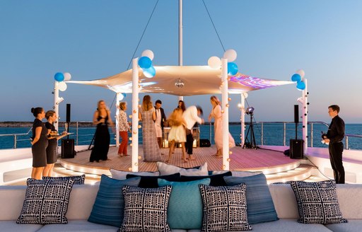 Charter guests onboard charter yacht STARBURST IV on the dancefloor