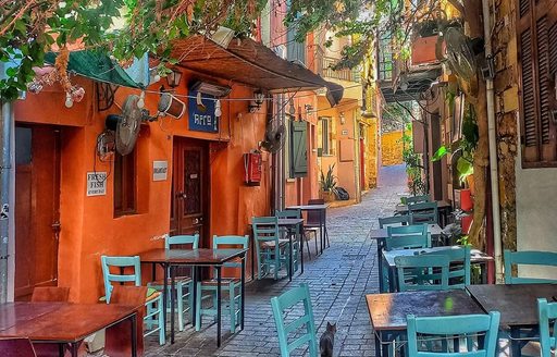 Old Venetian Port of Chania Crete cobbled street with tables