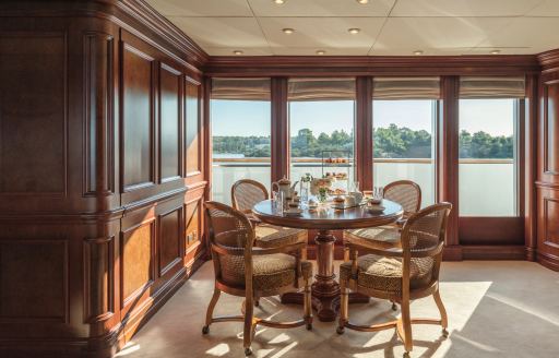 Charter yacht NOMAD interior seating around a circular table