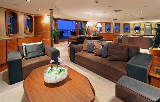 Comfortable sofa and armchairs in main salon of charter yacht Sherakhan 