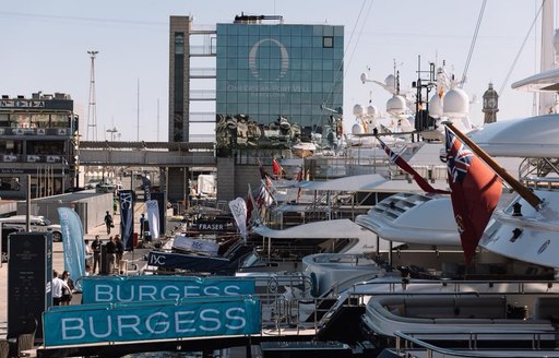 superyachts lined up decorated in brokerages' bunting in OneOcean Port Vell for The Superyacht Show