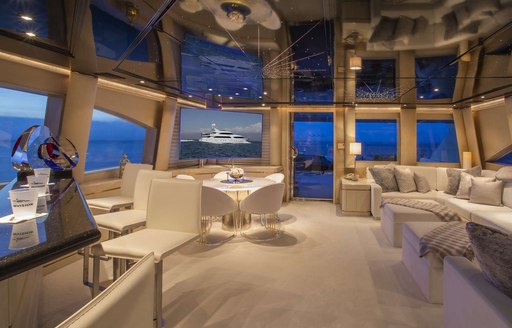 Main salon aboard luxury yacht INVISION with star panelled ceiling 