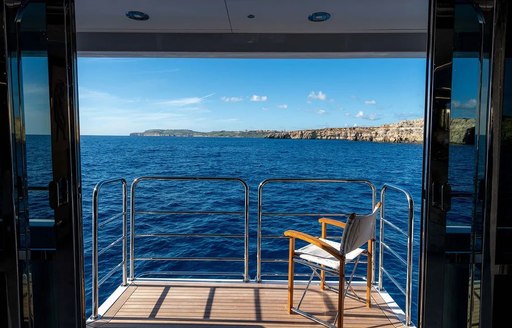 Luxury charter yacht ANYA unfolding sea terraces, with chair overlooking the ocean