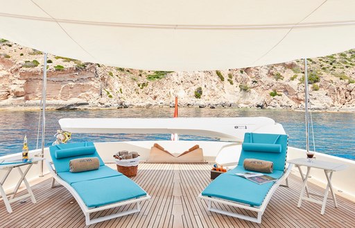 sun loungers under a canopy on board luxury yacht DEVA