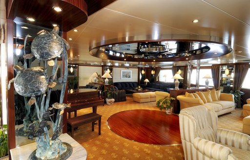 Superyacht Lauren L main salon, with grand piano and lounging areas