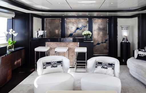 Elegant skylounge on superyacht Lady Li, with bar and textured artwork