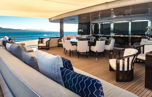 Comfortable seating areas and tables on deck of superyacht RARITY