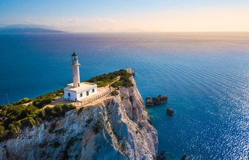 White lighthouse on a cliff top in Greece