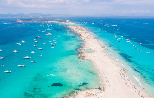 aerial shot of ses illetes beach in fomentera, blue sea and sandy beach