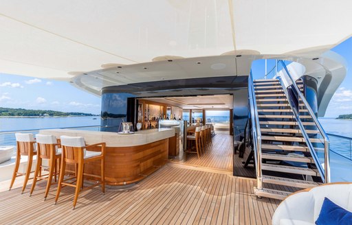 charter yacht sundeck with bar area and indoor-outdoor lounge space