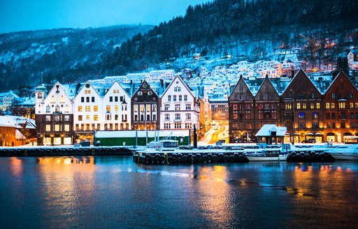 snowy houses by the water in norway