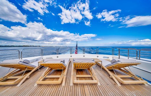 Charter yacht NATURAL 9 line of sun loungers on deck