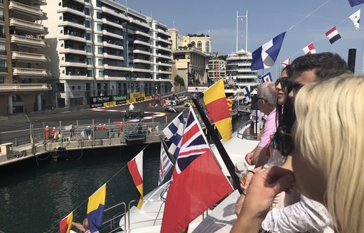 Spectators watch a Formula one car racing at the Monaco Grand Prix