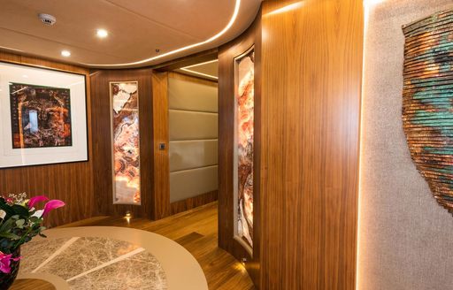 Corridor on luxury sailing yacht ARESTEAS, with pictures on walls