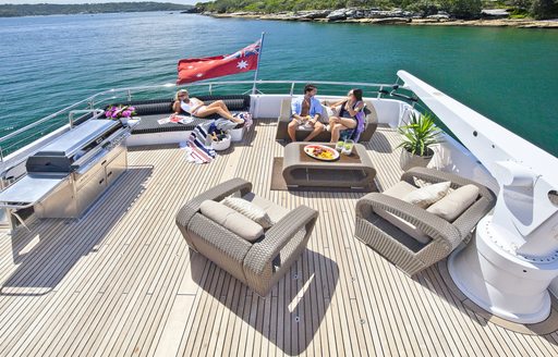 charter guests relax on the sundeck of motor yacht Quantum