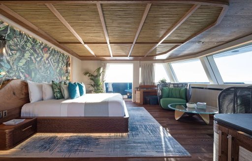 Master cabin onboard charter yacht KING BENJI, central berth facing forward with multiple windows 