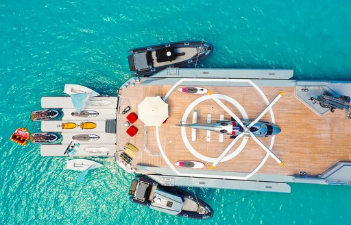 aerial view of luxury yacht bold, with helipad and toys