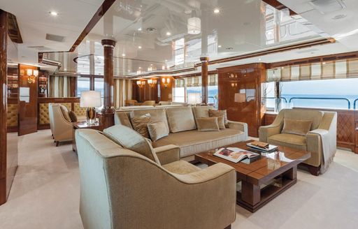 forward seating area in traditional styling on board luxury yacht CHECKMATE 