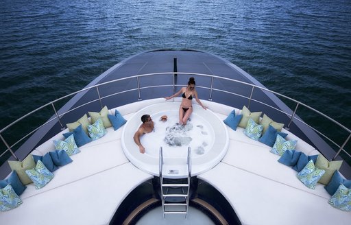 guests relax in Jacuzzi on sundeck of motor yacht Ocean Emerald 