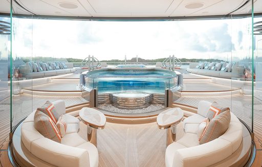 Deck and pool space on board luxury charter yacht KISMET, with cream coloured design
