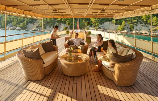 Exterior lounge area onboard charter yacht SEAGULL II, with charter guests enjoying views