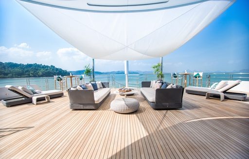 luxe deck area with seating, sun loungers and Bimini aboard luxury yacht SALUZI