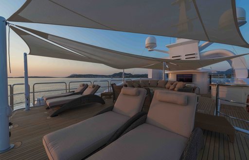 Sun loungers under awnings on sun deck of motor yacht Mine Games