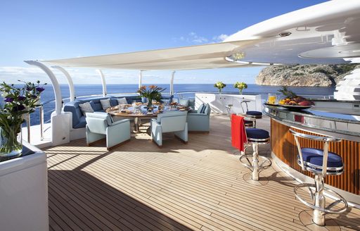 Sun deck on charter yacht SYCARA V with dining and wet bar