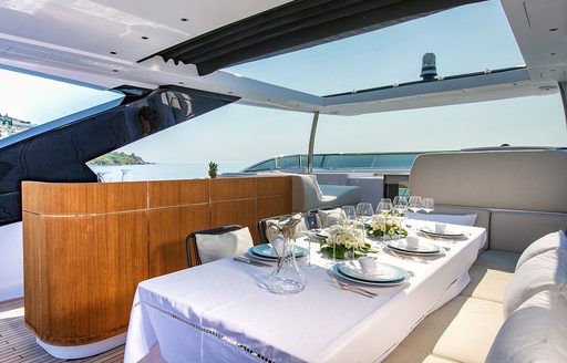 Formal dining area under retractable roof on luxury yacht ARSANA