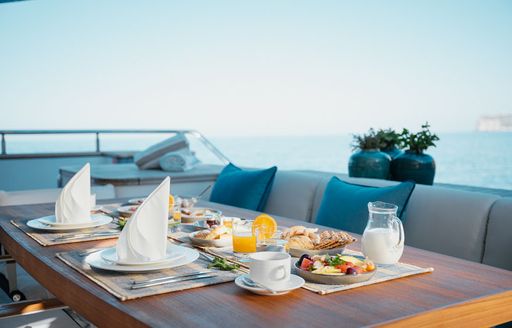 Laid dining table on board explorer yacht SEAL