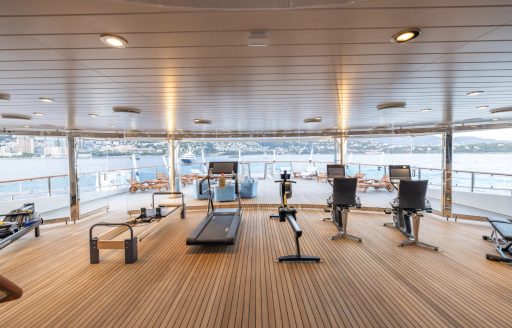 Overview of the gym onboard charter yacht CARINTHIA VII, with panoramic view through extensive glazing