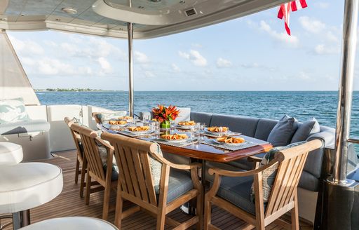 main deck aft's alfresco dining table aboard luxury yacht TEMPTATION
