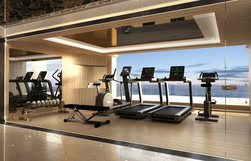 Gym onboard superyacht charter KISMET, with exercise equipment facing out of a large full-height window