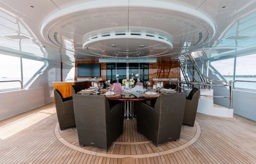 Alfresco dining arrangement onboard charter yacht REMEMBER WHEN, circular table set for a meal